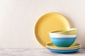 Crockery and cutlery on a light table.