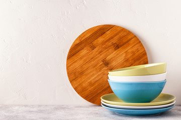 Crockery and cutlery on a light table.