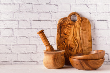 Wooden tableware on a white table.
