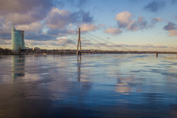 Stunning cloudy sunset at bridge at Riga, Latvia