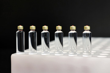 Quality Control vials for injection. Individual checks vial under a microscope. New pharmaceutical. Production of sterile medications. Pharmacology and people together. The ampoule under a microscope.