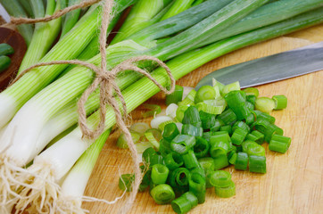 Spring onions are rich in vitamins,minerals and natural compound.
Green onions or Spring onions on wooden board cutting.