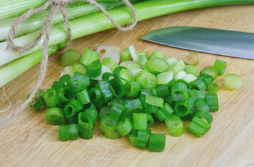 Spring onions are rich in vitamins,minerals and natural compound.
Green onions or Spring onions on wooden board cutting.
