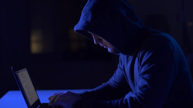hacker using laptop computer for cyber attack