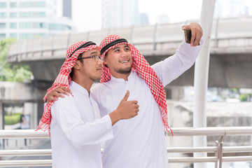 couple arabian businessman using smart phone selfies when travel in city