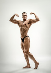 Fototapeta na wymiar athletic guy - bodybuilder, pose on white background