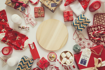 Christmas background with handmade presents wrapped in craft paper, cup of hot chocolate. Flat lay. Space for copy