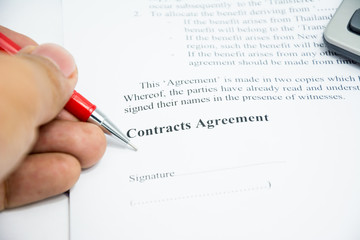 contracts agreement sign on document paper with red pen