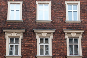 Six Windows on the facade of the red brick house