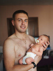 happy father holds newborn son