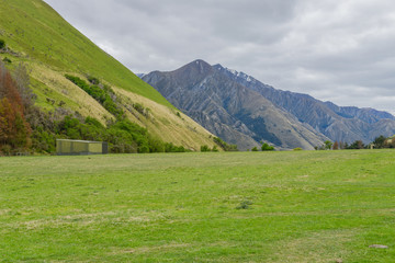 Fototapeta na wymiar Meadows side the mountain and cabin in New Zealand Southland