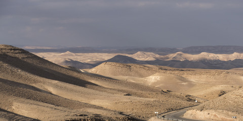 Fototapeta na wymiar Road passing through a desert, Judean Desert, Dead Sea Region, Israel