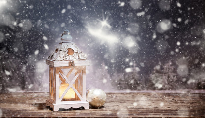 Fototapeta premium christmas lantern and snowy firs in the background