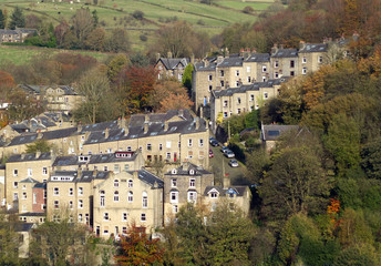 sloping street and tall housed in hebden bridge surrounded by pennine countryside