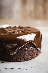 Creamy cake with chocolate glaze on the rustic background. Selective focus. Shallow depth of field.