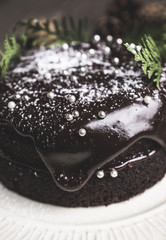 Creamy cake with chocolate glaze on the rustic background. Selective focus. Shallow depth of field. Toned image.