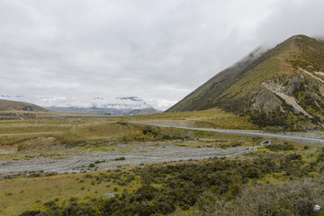 Fototapeta na wymiar Foggy mountains and meadow in New Zealand
