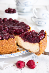 Homemade cheesecake with cherries on a plate