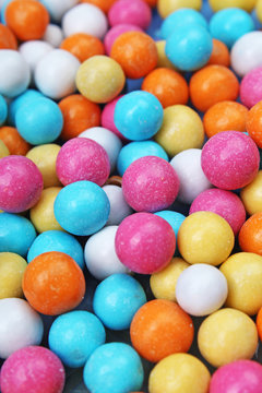 Shiny sugar coated round chocolate balls as background. Candy bonbons multicolored texture. Round candies sweets pattern concept. Food photo studio photography. Candy background. Texture background.