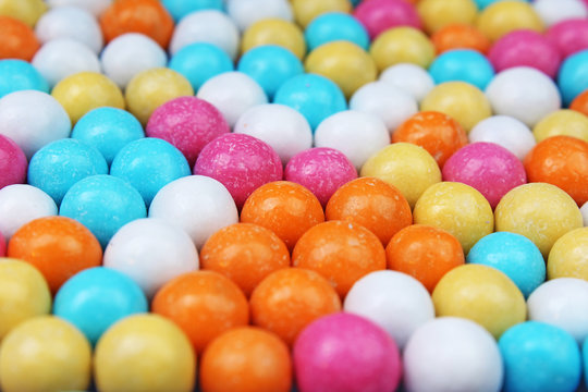 Shiny sugar coated round chocolate balls as background. Candy bonbons multicolored texture. Round candies sweets pattern concept. Food photo studio photography. Candy background. Texture background.