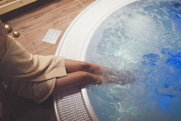 Woman enjoying jacuzzi at spa resort - obrazy, fototapety, plakaty