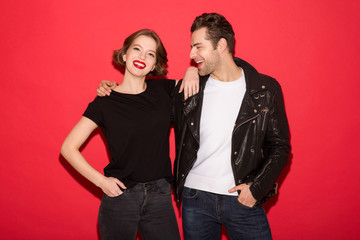 Image of cheerful punk couple hugging and posing together
