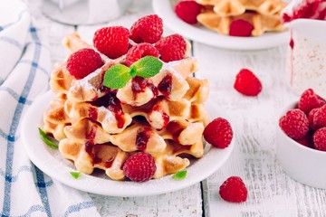 Homemade waffles with fresh raspberries for breakfast