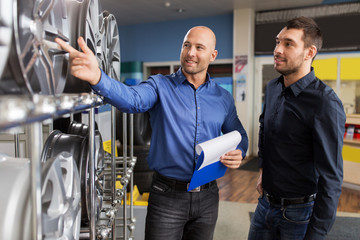 customer and salesman at car service or auto store