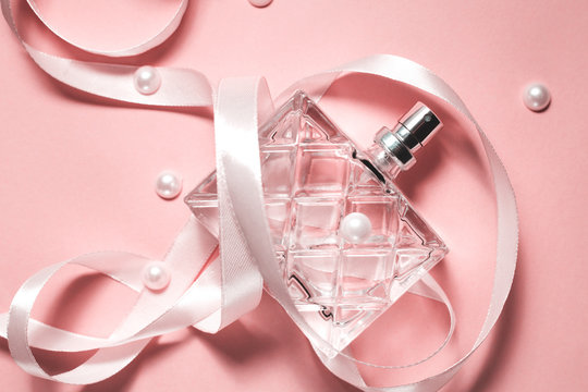 Bottle of modern perfume on pink background