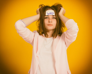 Fototapeta na wymiar Young cute girl, sticker on a head, studio 