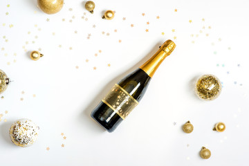 Bottle of champagne and gold Christmas balls