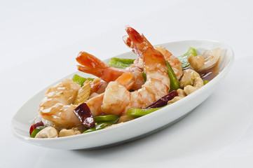 cajun Shrimps with cashew nuts stir fry vegetables on white plate with white background 