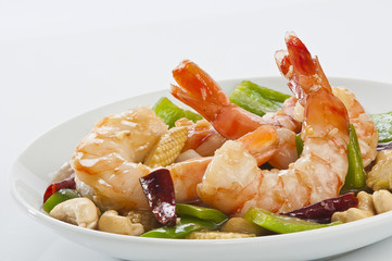 cajun Shrimps with cashew nuts stir fry vegetables on white plate with white background 