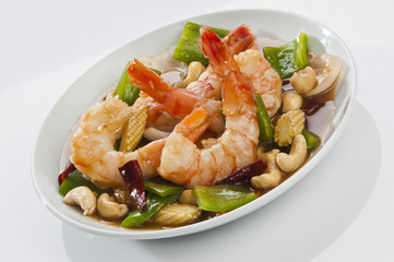 cajun Shrimps with cashew nuts stir fry vegetables on white plate with white background 