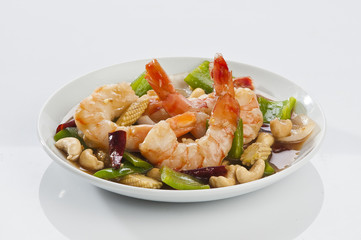 cajun Shrimps with cashew nuts stir fry vegetables on white plate with white background 