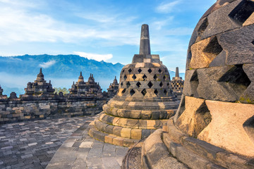 Candi Borobudur in the background of rainforest, morning mist and Sumbing Mountain. Borobudur, Yogyakarta, Jawa, Indonesia.