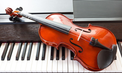 Violin on piano key. Top view. Music instrument. Art and music background.