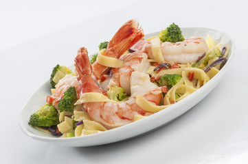 Jumbo Shrimp Pasta with broccoli & Vegetable with cheesy white gravy on white plate with white background 