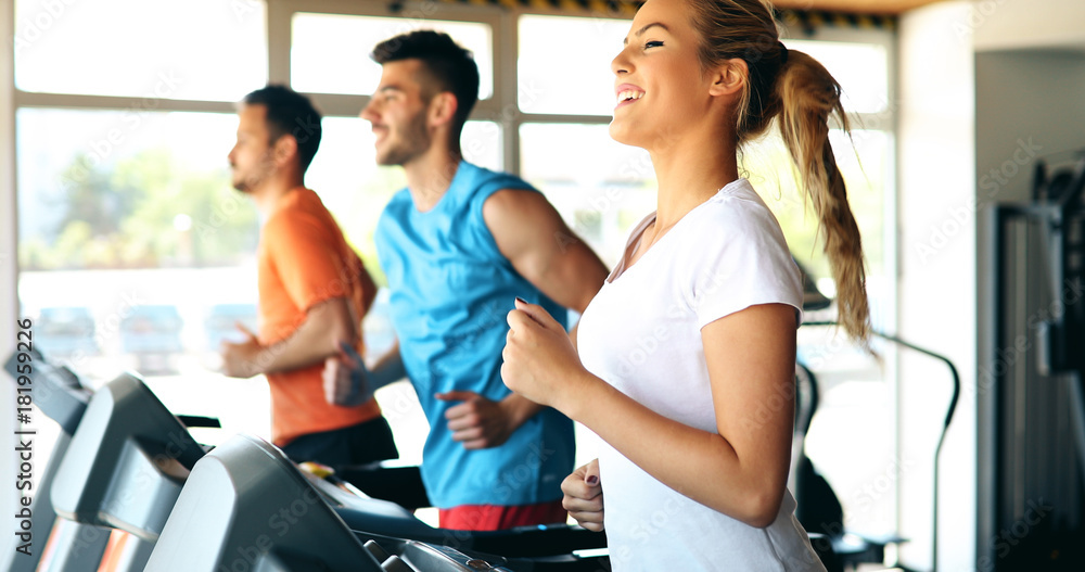 Wall mural Picture of people running on treadmill in gym