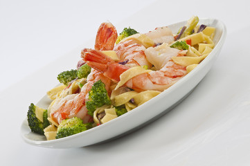 Jumbo Shrimp Pasta with broccoli & Vegetable with cheesy white gravy on white plate with white background 