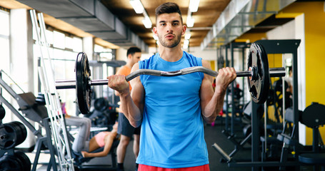 Obraz premium Determined male working out in gym