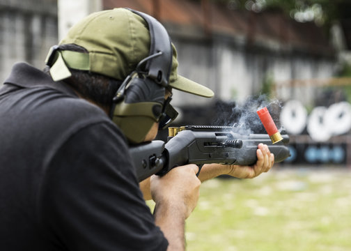Man shooting on an outdoor shooting range, selective focus