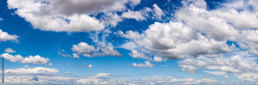 Wall mural Blue sky with white fluffy clouds panorama