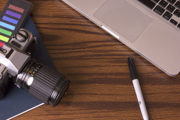 Designers desktop with camera and laptop