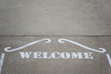 Welcome stenciled on the ground