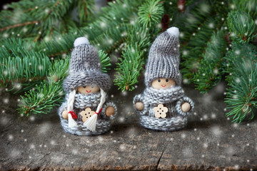 Two little toys decoration on wooden background. Christmas or New Year concept