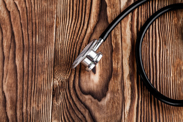 stethoscope on wood background