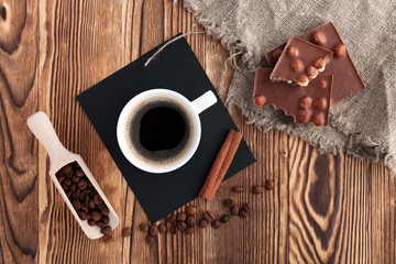 Coffee cup and cookie on wood