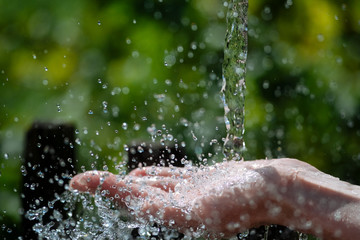 A spray of water on a woman's hand.