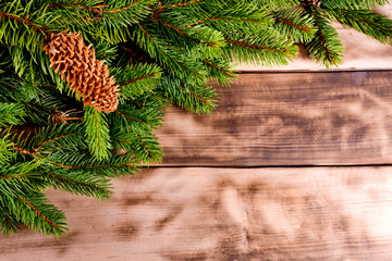 Christmas fir tree on natural wooden background.